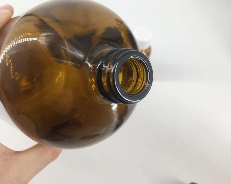 Wholesale Amber Boston Round Glass Amber Essential Oil Glass Spray Bottle with Various Accessories Accept Customization