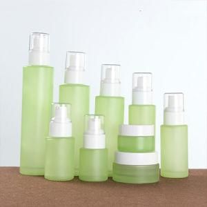Customized Clear Green Frost Cosmetic Lotion Glass Bottle with Spray Lotion Pump for Cosmetic Packaging